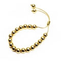 Detail of adjustable gold beaded bracelet featuring a slide clasp and polished round beads - 6mm Gold