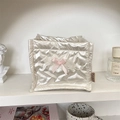 Close-up of heart-stitched cream storage box with pink bow and lace trim details - Heart Creamy White
