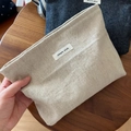 Close-up of minimalist canvas pouches in beige and navy with Simple Wish fabric label - Solid Beige