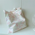 Detailed view of floral canvas tote bag with pink flowers and a vintage cloth label - Pink Sakura