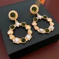 Detail of vintage gold earrings with green stones and crystals on a black jewelry box - Vintage Green Gem Square Style (3#)