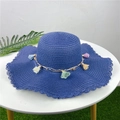 Detail of navy straw hat with wavy brim and colorful floral tassels and beads - Navy Blue