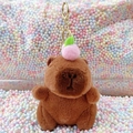 Brown plush Capybara keychain with a pink peach on head and a golden metal clip - Dark Brown Peach + Gold Clip