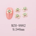Macro view of gold bow-knot nail charm with green heart gemstone, 9.5x8mm size detail - Gold Bow + Green Heart Stone (9982)