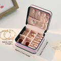 Pink portable mini jewelry box for girls featuring blue trim and suede interior - Pink