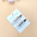 Close-up of pearl white acetate hair clips with gold metal base on display card - Acetate Pink White 1 Pair