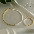Elegant pearl and gold bead necklace and bracelet set on soft silk fabric background - Set - Half Pearl Half Gold Bead