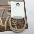 Beige ribbed elastic hair tie with a small leather buckle detail on white card - Beige Striped