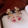 Detailed macro of 18k gold plated floral earrings with colorful vibrant rhinestones - Multicolor Silver Needle (Stud & Clip Integrated)