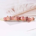 Close-up of golden hair clip with pink and orange natural crystal stones - Strawberry Quartz + Gold Clip