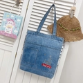Blue denim tote bag featuring white graphic print and two front pockets in washed finish - Style 1 Light Blue (Printed)