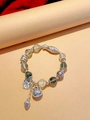 Detail view of ethnic green crystal bracelet with silver fish and lotus flower charms - Green Ghost: Abundance Every Year Lotus Leaf Bracelet