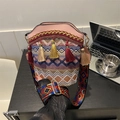 Ethnic bohemian bucket bag with colorful woven patterns and tassel details in pink - Pink