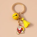 Detail of Christmas keychain with Santa Claus charm, yellow bell, and soft tassel accent - Yellow Santa Claus
