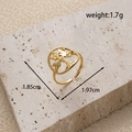 Gold stainless steel tree of life open ring on beige stone base with size markings - Hollow Tree of Life Open Ring