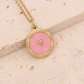 Close-up of gold necklace with pink enamel circular pendant and small heart detail - Pink Medallion with Gold Heart (7#)