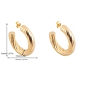 Detail of 35mm golden twisted hoop earrings with 7mm thickness measurements - Twisted C-Shape