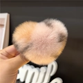 Macro detail of the plush heart-shaped hair clip showing soft gradient faux rabbit fur - Pink Leopard