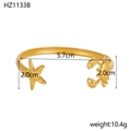 Detail view of gold stainless steel bangle with starfish and crab charms, size 5.7cm - Gold Starfish Crab (HZ1133B)