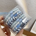 Detail of blue woven hair ties set with oval beads in a clear plastic gift box - Blue Series Set