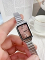 Close-up of elegant silver rectangular quartz watch with a pink dial on metal strap - Silver Pink Dial
