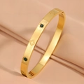 Luxury gold titanium steel open bangle featuring green stones and clover engraving - Green Zirconia / Gold