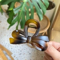 Close-up of tortoise shell bow hair claw clip with golden metal spring mechanism - Approx. 8cm / Matte Light Tortoise