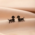 Macro shot of black dachshund dog earrings on luxury champagne silk fabric texture - Sitting Dachshund (780) / Black