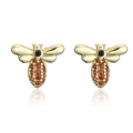 Macro shot of gold-plated bee earrings with amber and black zircon stones on white backdrop - Gold-Bee-Orange