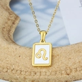 Golden Leo zodiac pendant necklace with white enamel inlay on a delicate link chain - Leo
