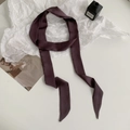 Deep purple narrow silk scarf tied in a ribbon style on a minimalist white background - 200cm / Deep Smoky Red