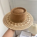 Handmade raffia straw hat with geometric woven patterns and a brown ribbon trim - Raffia Hollow Indented Hat - Khaki
