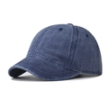 Macro view of washed navy blue cotton baseball cap showing vintage texture and short brim - Adjustable / Navy Blue