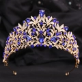 Detail of baroque crown showing golden leaf patterns with blue crystals and gems - KC Gold White & Blue Rhinestone