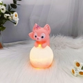 Pink fox night light on a glowing sphere atop a white plush rug for bedroom decor - Little Fox Night Light Lying