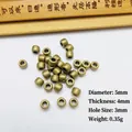 Detail view of 5mm vintage brass spacer beads with dimensions and hole size for DIY jewelry - 5x4mm / Antique Bronze
