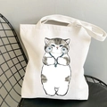 White canvas tote bag featuring a cute chubby grey cat illustration with blue flowers - Cat with Blue Flower