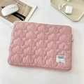 Detail of pink cloud-quilted laptop sleeve with zipper and Cloud Hugger woven label - 11" / Pink