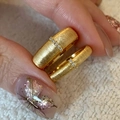 Close-up of brushed gold rings with micro-inlaid gemstones held between fingers - Gold Narrow Brushed Style (J5236)