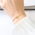 Chic red string and gold chain bracelet featuring a round green gemstone inlay - August Olive