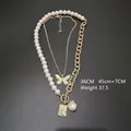 Detail view of layered baroque pearl and portrait medallion necklaces with 36CM and 45CM lengths - Pearl Butterfly Gold