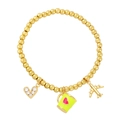 Detail of beaded gold bracelet with airplane, heart zircon and enamel cup charms - Yellow