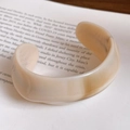 Minimalist wide open bangle in cream marble acrylic resin on vintage book background - Modern Minimalist Wide Round / White Amber Pattern