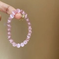 Detailed macro view of 8mm pink cat eye stone beads on a delicate beaded bracelet - Pink Cat's Eye Stone (8mm)