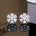 Macro shot of elegant floral stud earrings with sparkling round cubic zirconia crystals - Silver