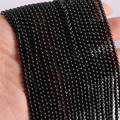 Close-up of polished 2mm black agate natural stone beads held by hand for DIY jewelry - 2mm (approx 170pcs) / Black Agate