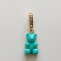Close-up of a turquoise resin gummy bear pendant with a gold crystal-encrusted clasp - Chic Blue