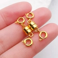 Pair of gold cylindrical magnetic jewelry clasps with spring rings shown on finger - Gold Cylindrical Double-Headed Magnetic Clasp / 26x7mm