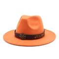 Close-up of orange wool fedora featuring a brown leather band and bronze flower buckle - Orange