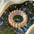 Exquisite pink and yellow beaded bracelet on a display stand with reflective mirror - S045 - Bright Orange Yellow - Jade Fragment Imitation Ceramic Bracelet #sz316